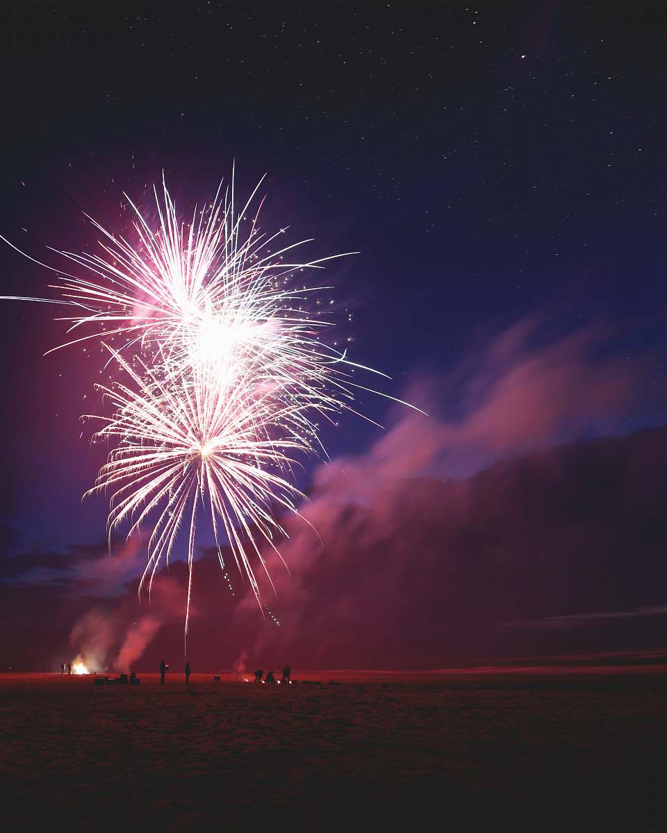 night people firing fireworks on bay during nighttime outdoors