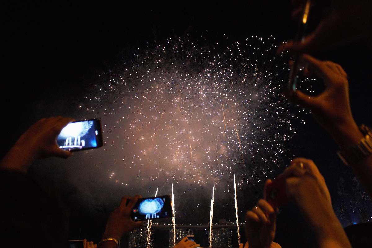 nature people taking photo of fireworks flare