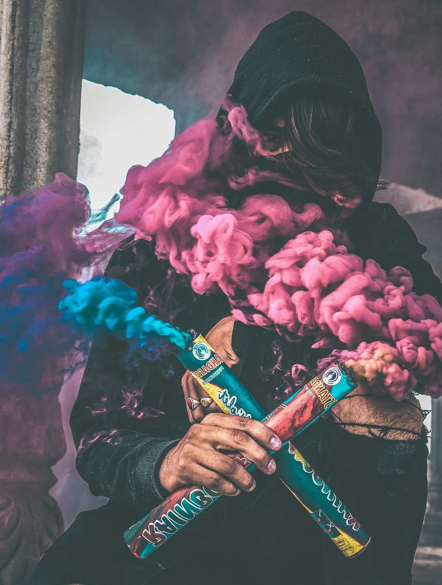 people person holding colored smoke human