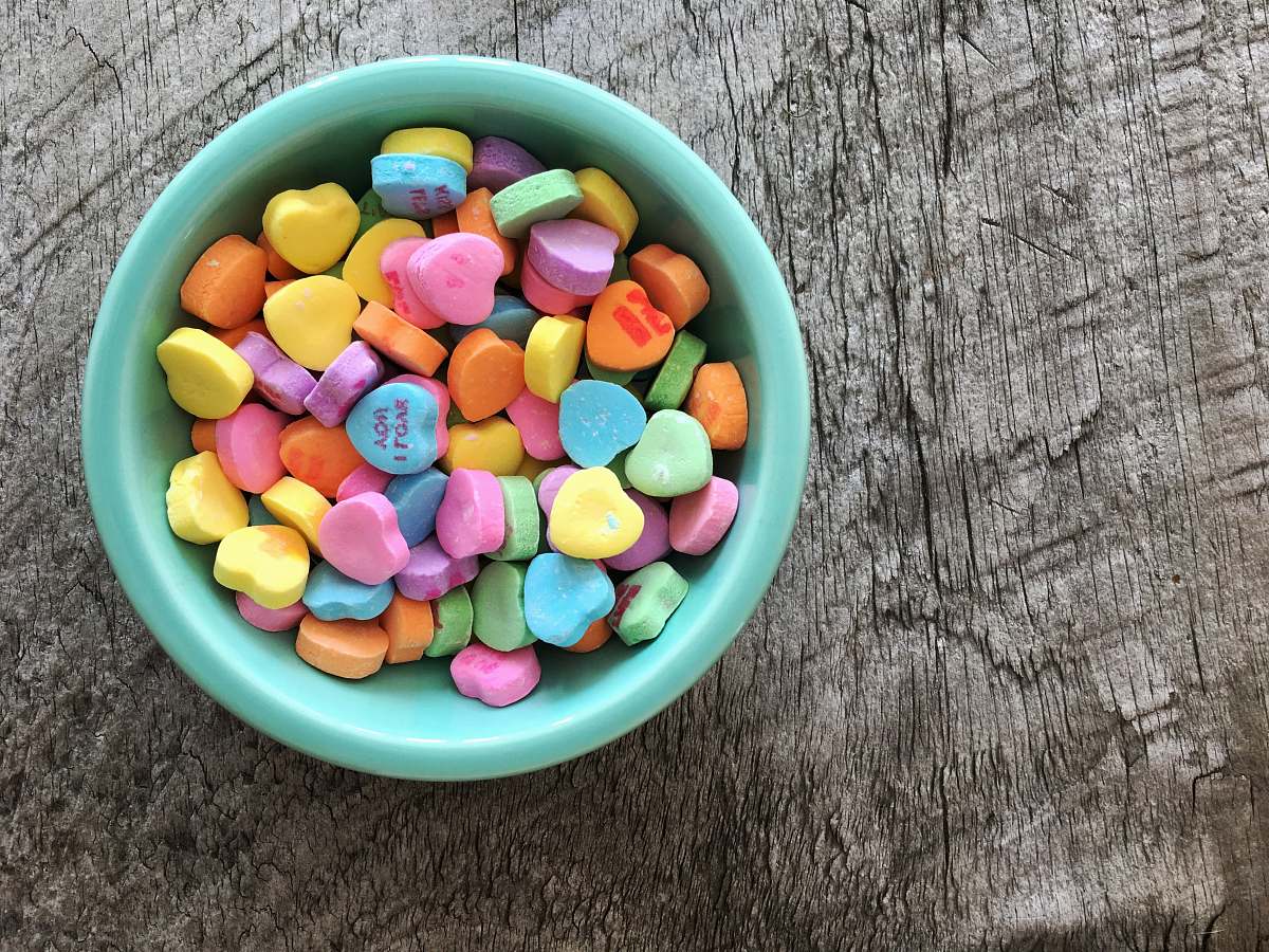 sweets assorted-color heart shape candies on teal bowl bowl