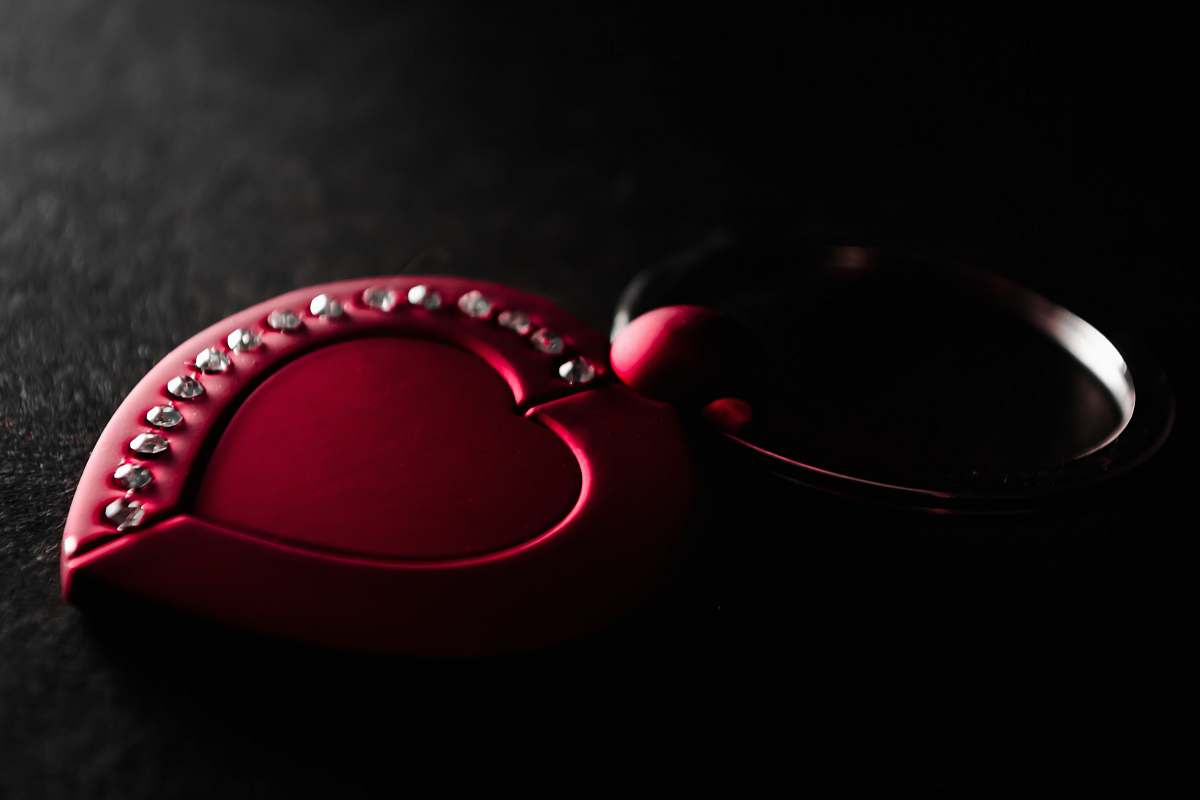 mouse red heart key chain on black surface computer