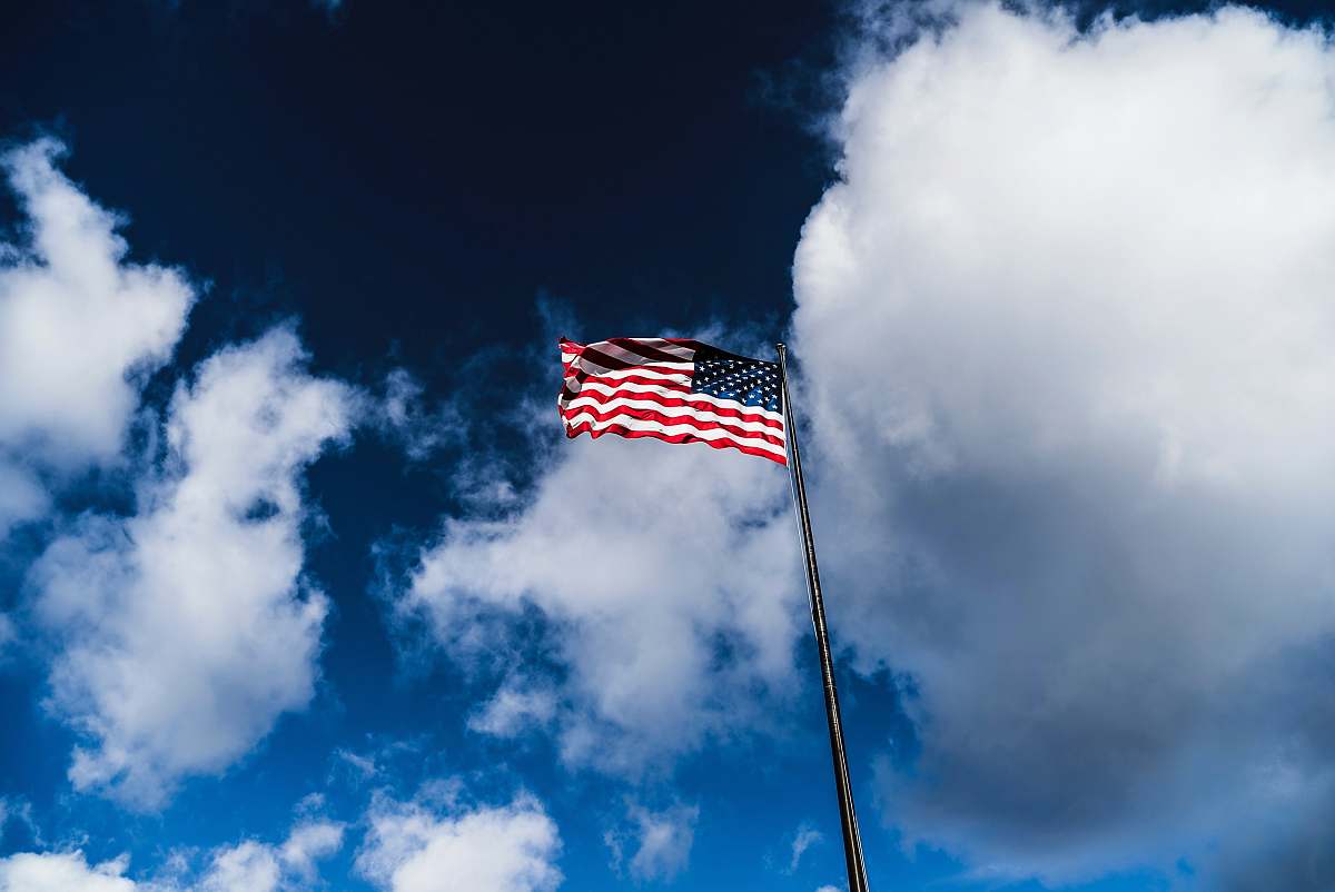 symbol flag of America on pole under cloudy sky new york