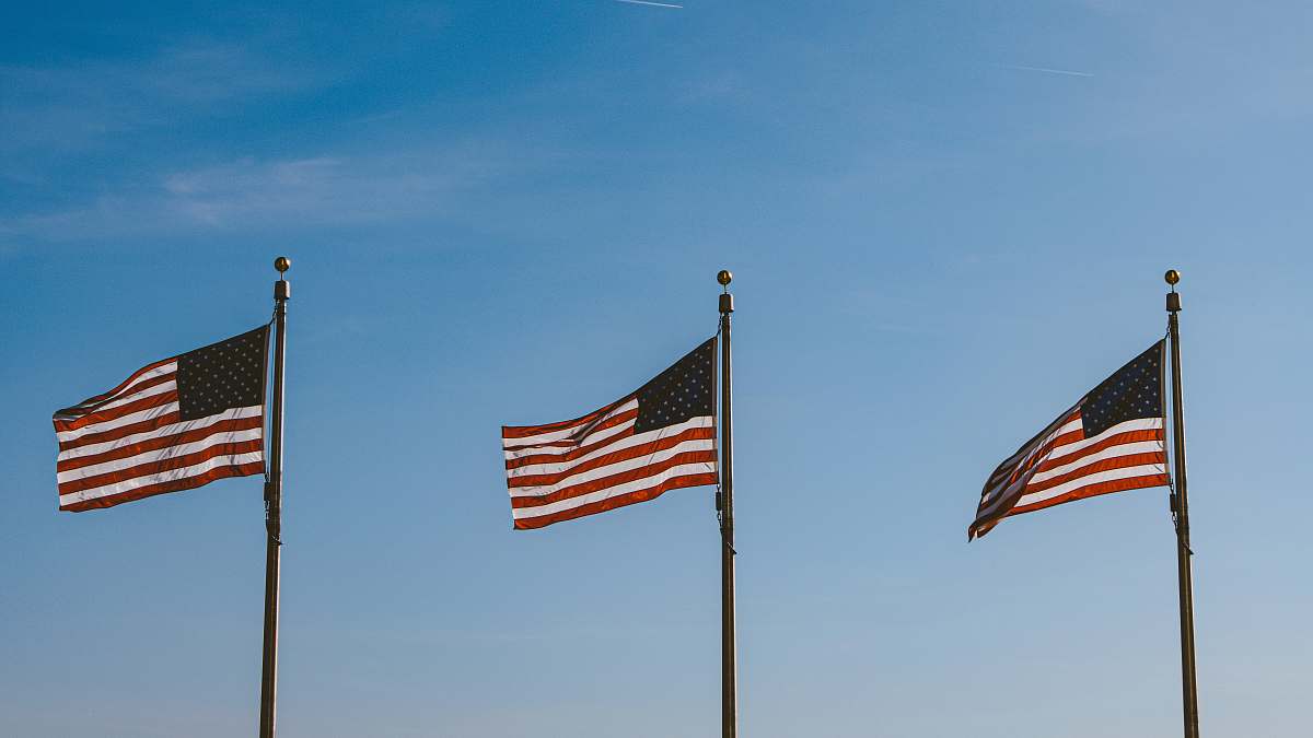 symbol three USA flags hanging on pole usa