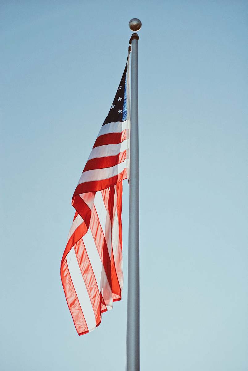 symbol US flag under clear sky at daytime american flag