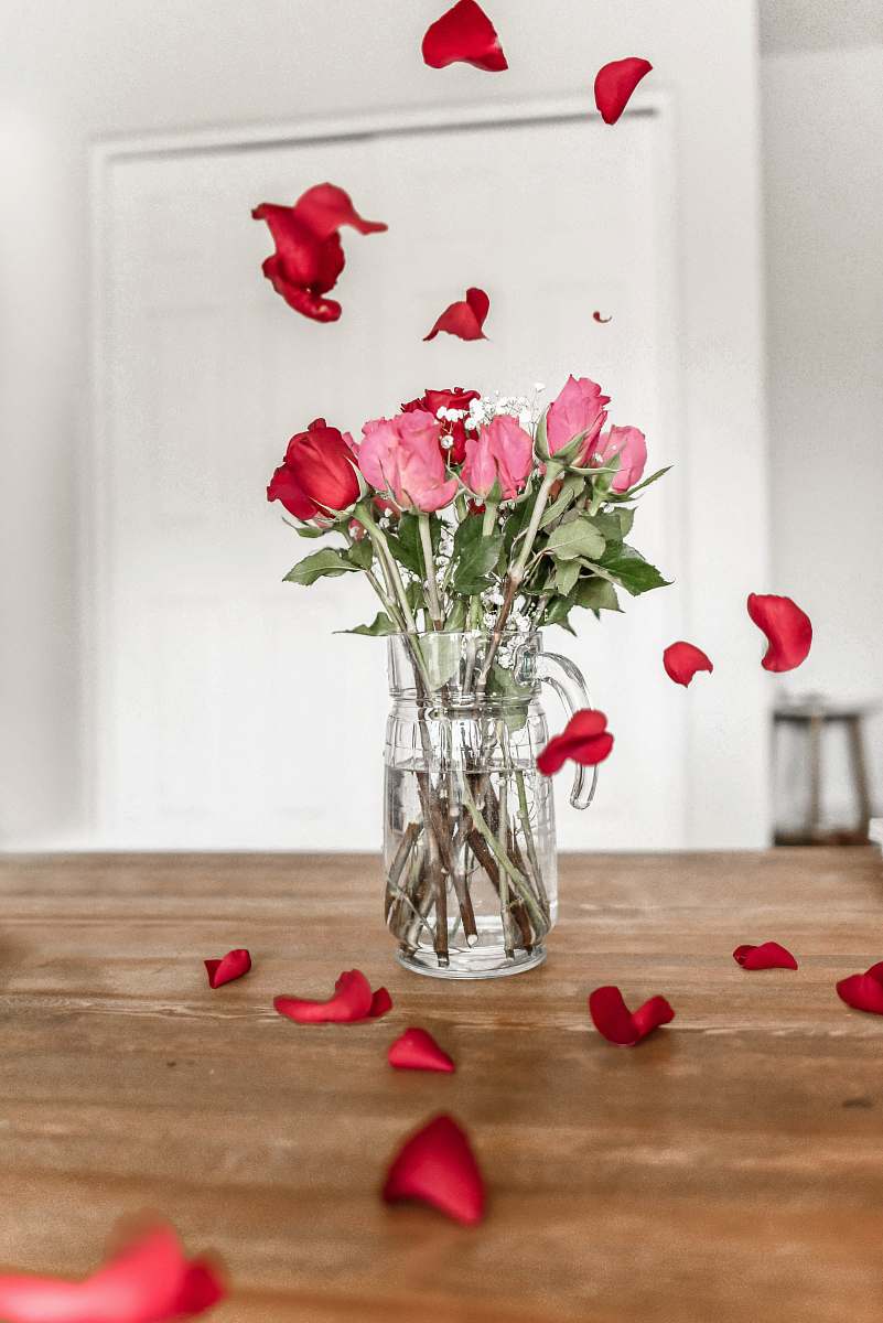 jar pink and red roses on clear glass vase vase