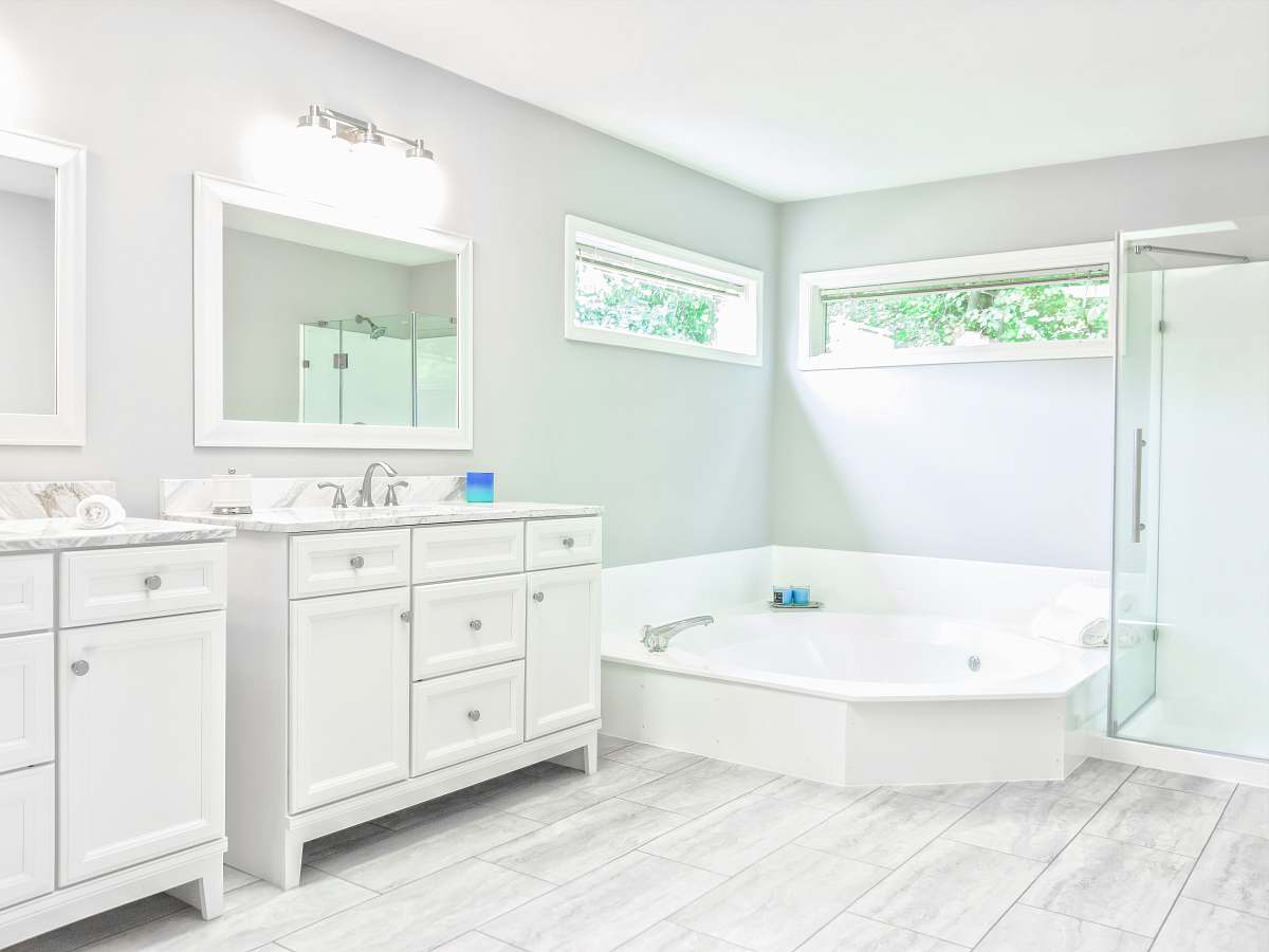 bathtub white ceramic bathtub near white wooden vanity sink tub