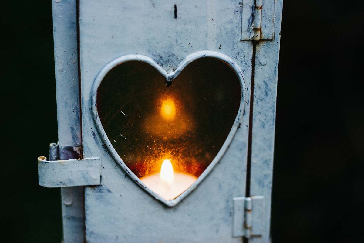 heart turned on candle lantern fire
