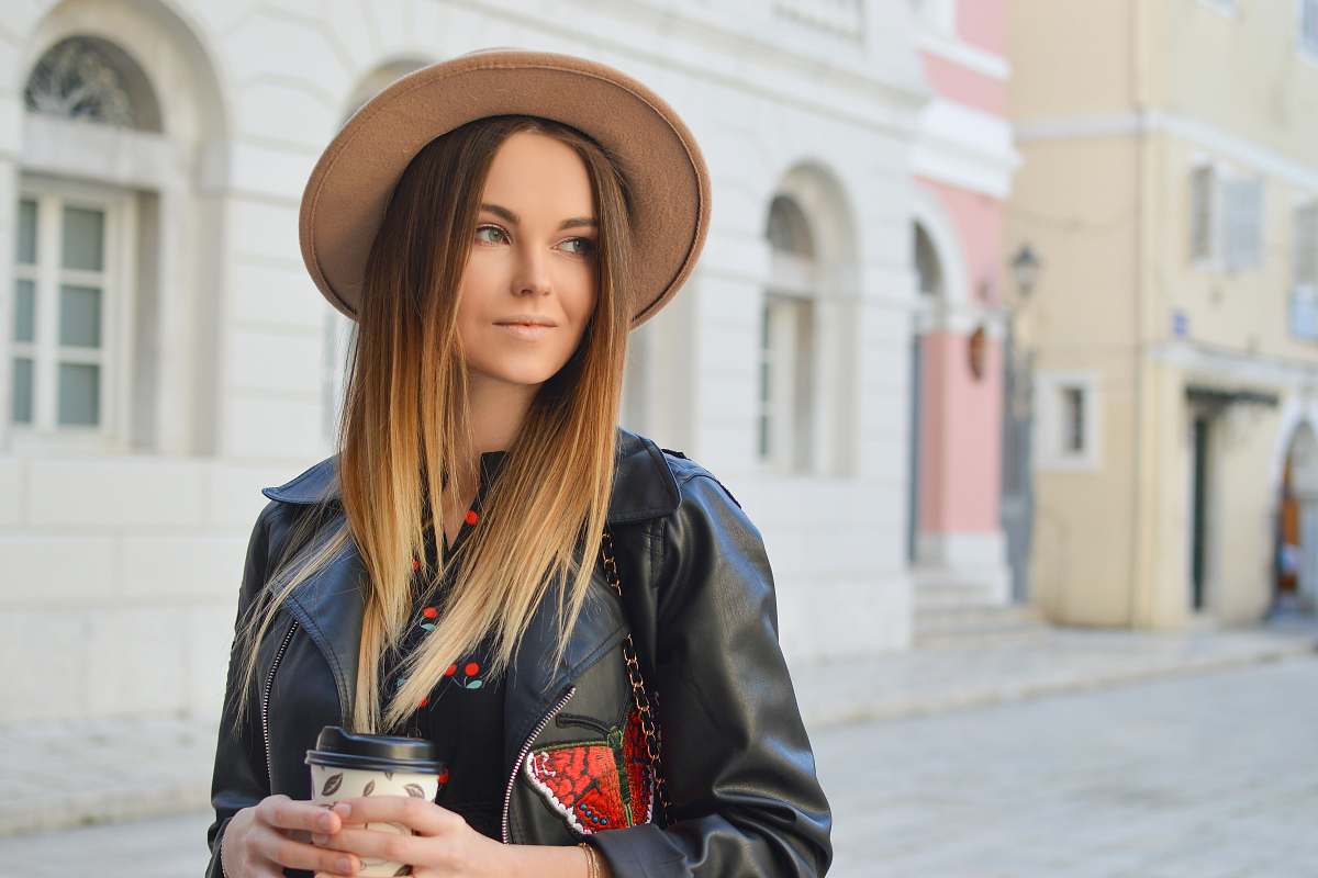 human woman looking left side while holding plastic tumbler woman