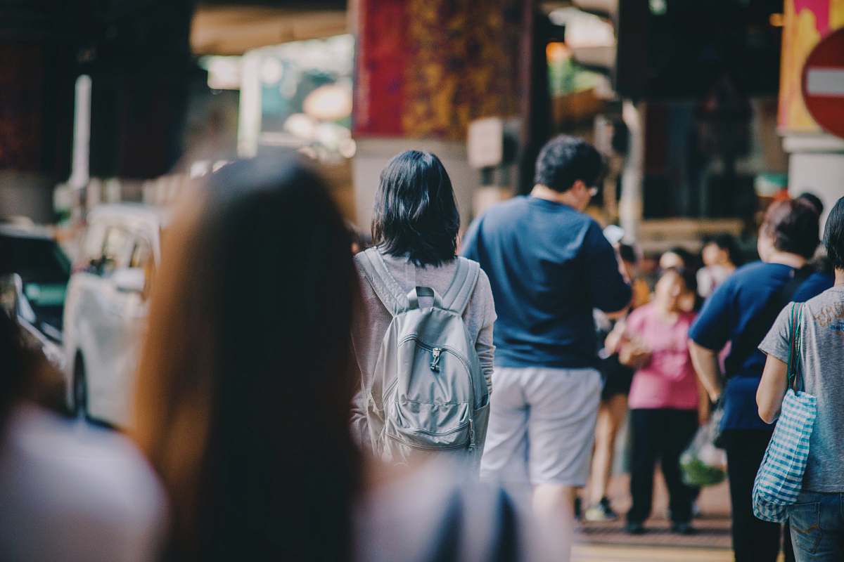 human woman standing in the middle of crowd person
