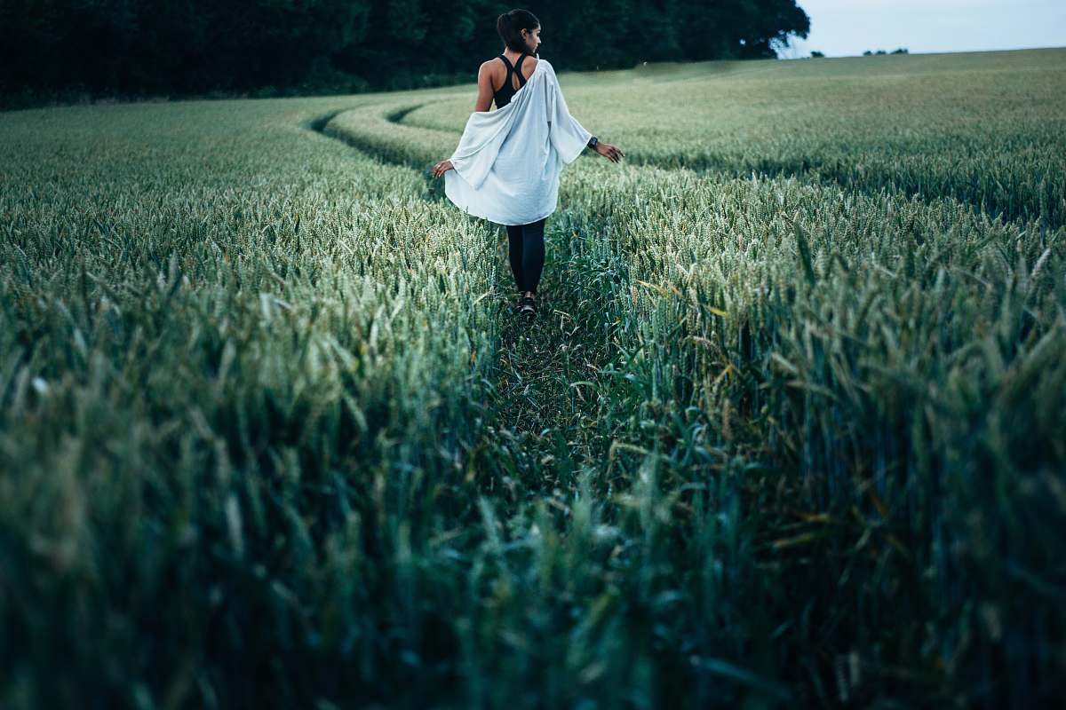 human woman walking on grass field woman