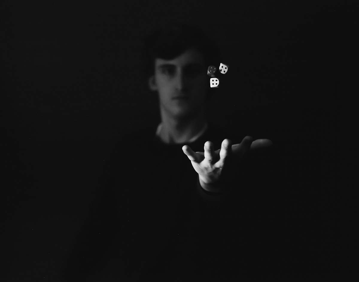 human may playing with three dices person
