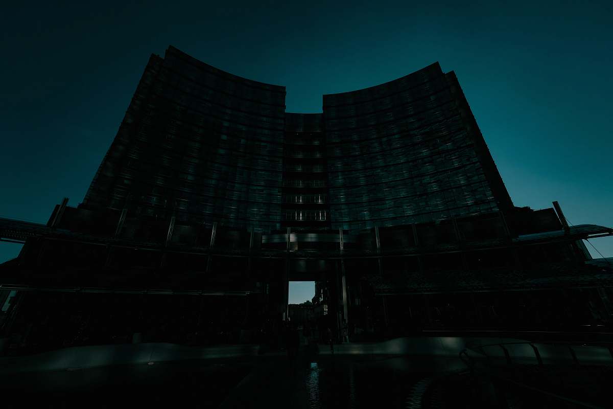 black low-angle photography of curtain wall high-rise building at dawn office building