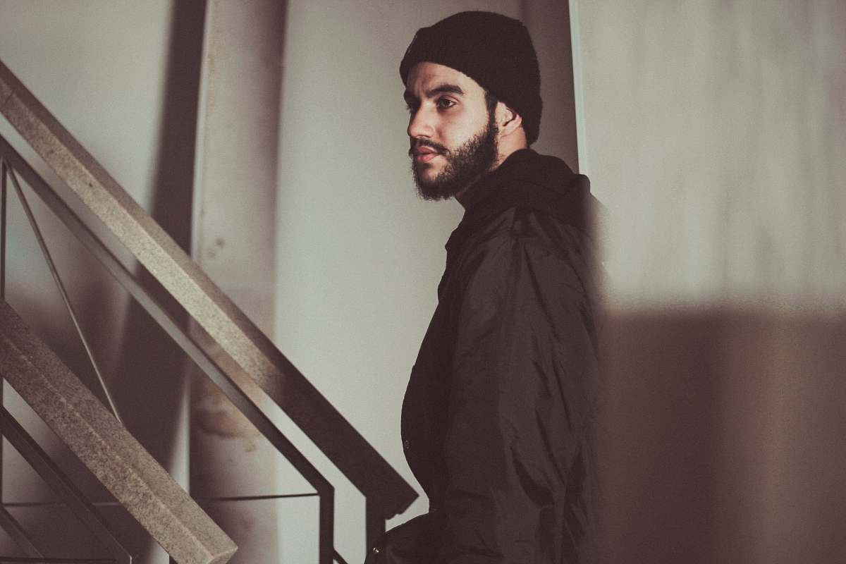 beard man standing near staircase man