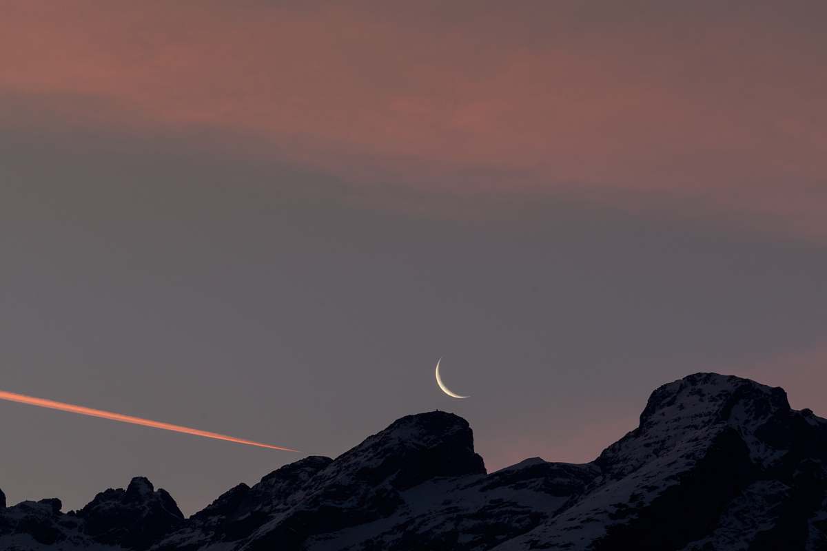 nature photo of black boulder and crescent moon moon
