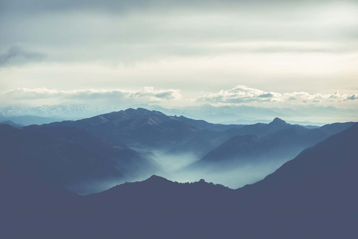 nature black rocky mountain under white cloudy sky outdoors