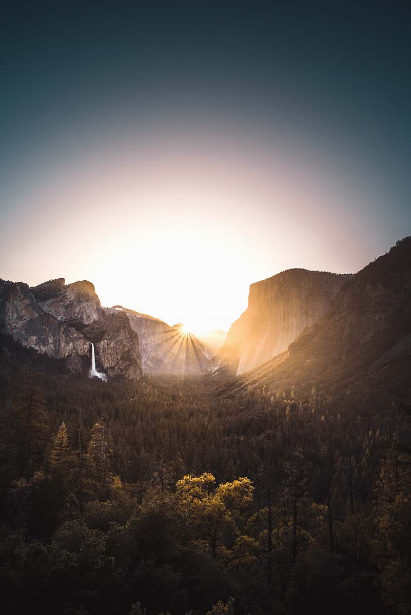 nature gray mountain surrounded with trees during sunrise sunset