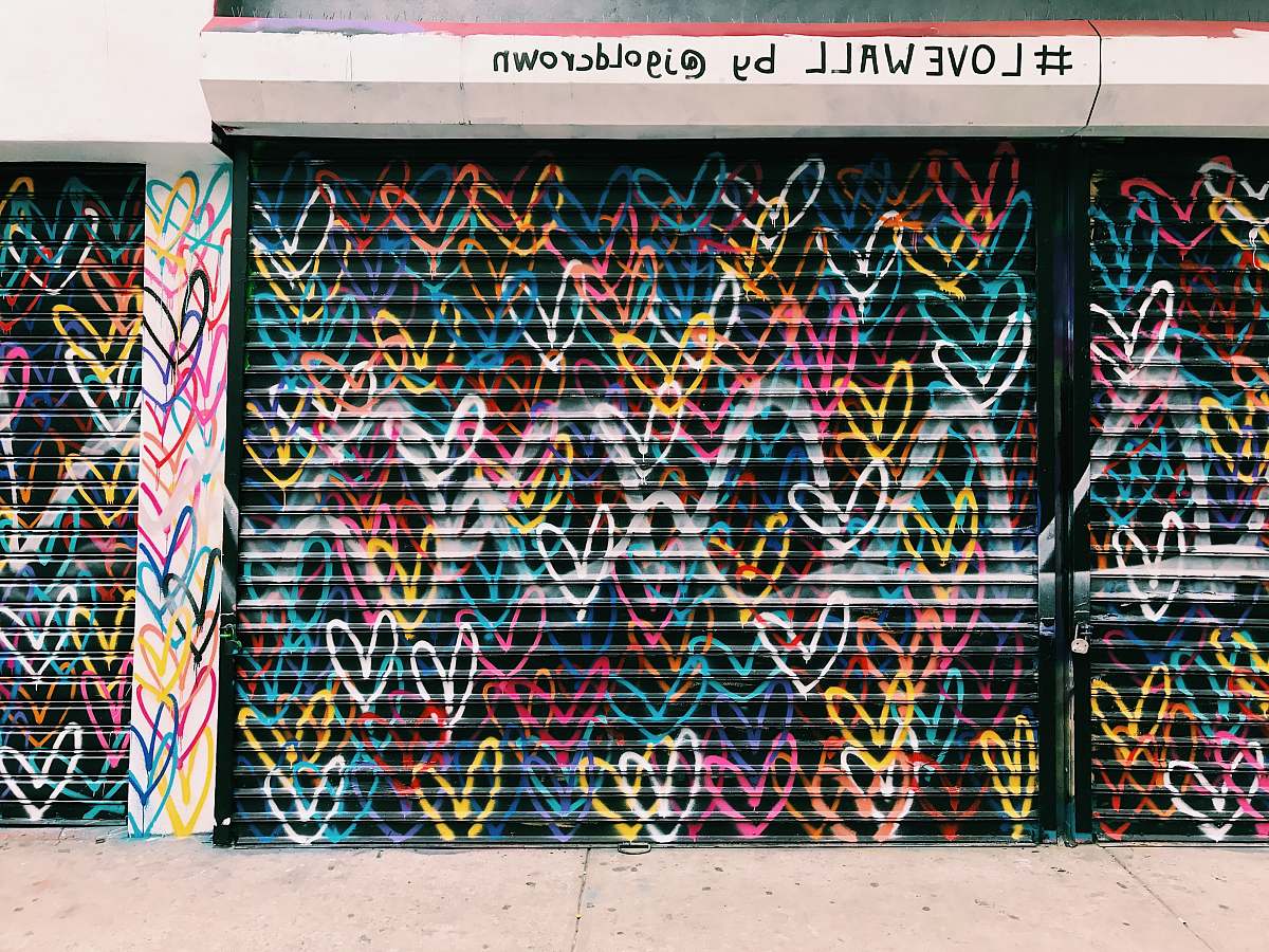 graffiti photo of black door shutter filled with heart murals love