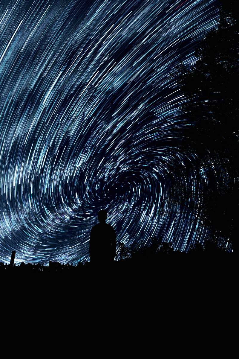 star silhouette photo of person standing sky