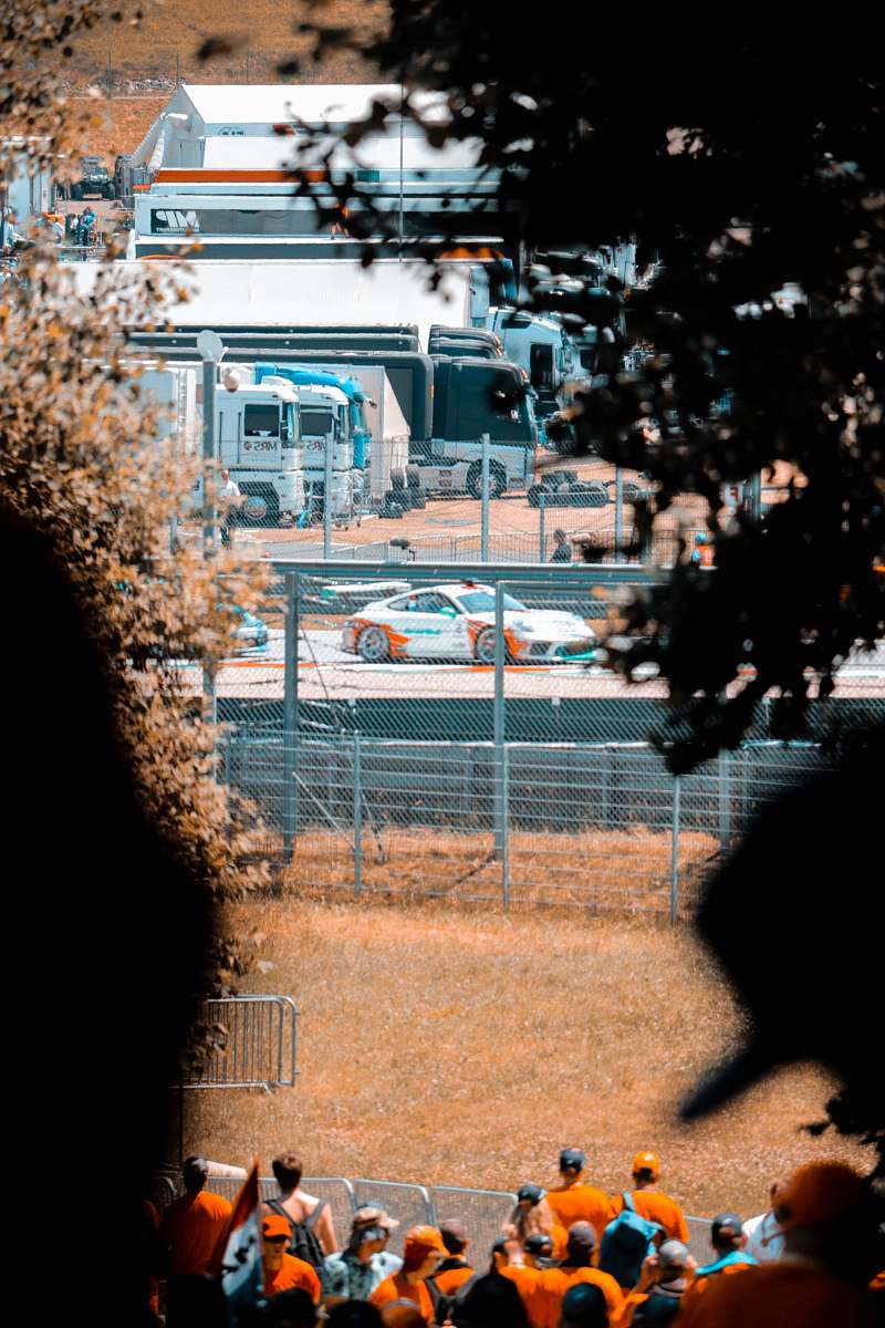 car people gathering near race track transportation