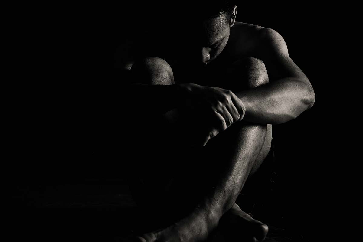 indonesia man sitting on black surface outer space