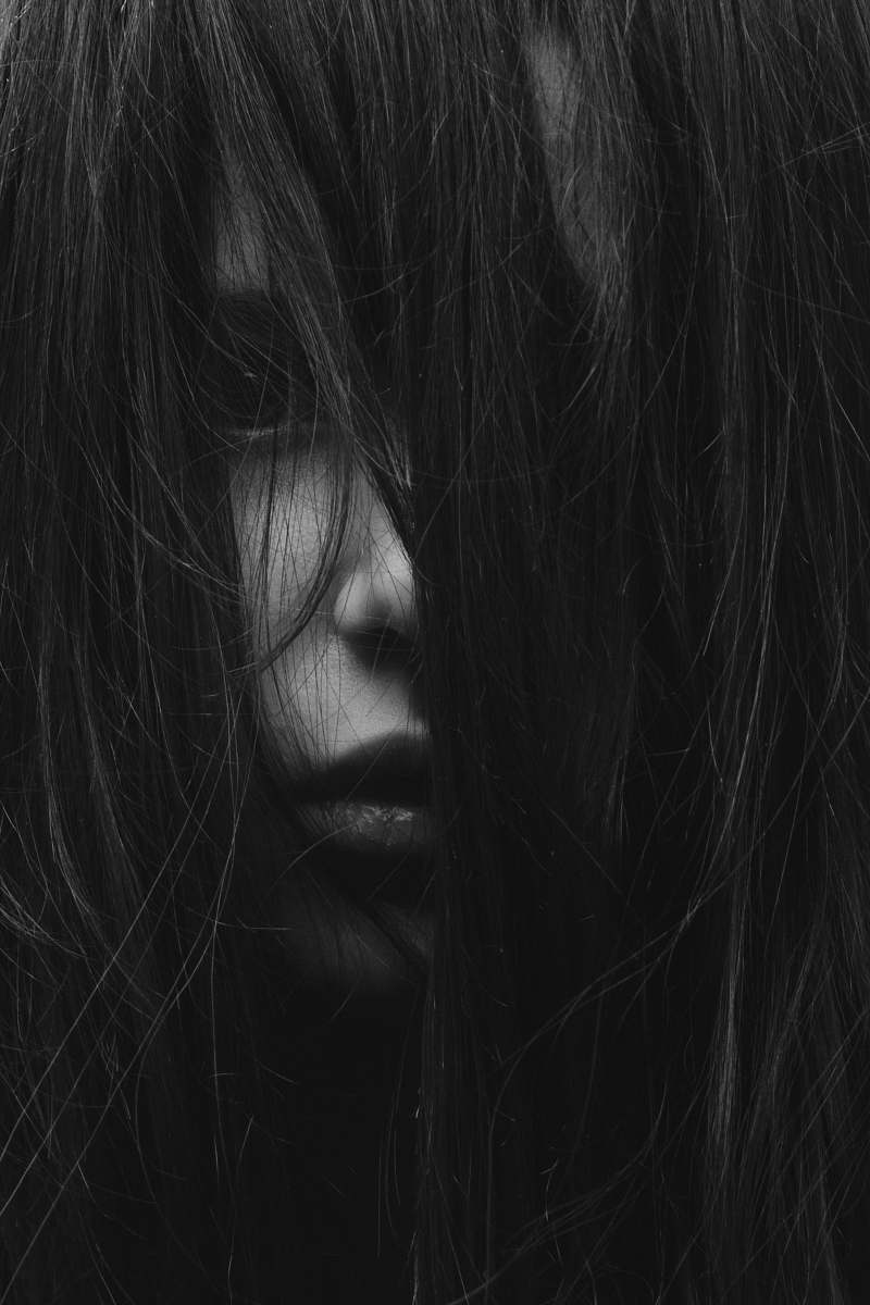 grey grayscale photography of girl covered her face with hair female