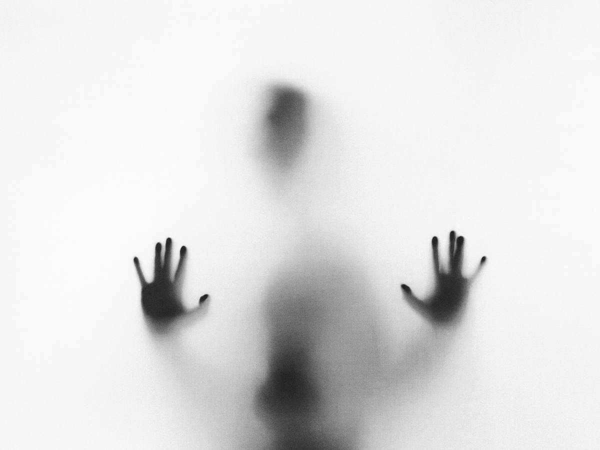 grey person behind fog glass halloween