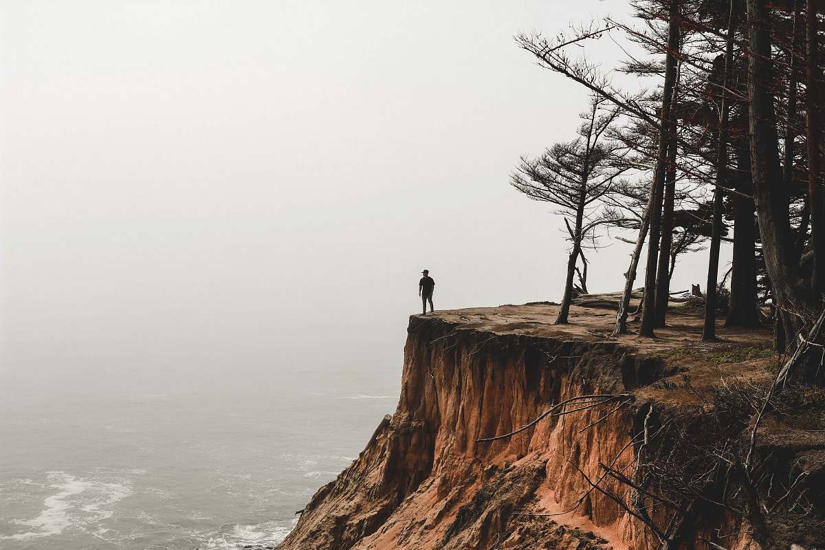 tree person standing on mountain cliff outdoors