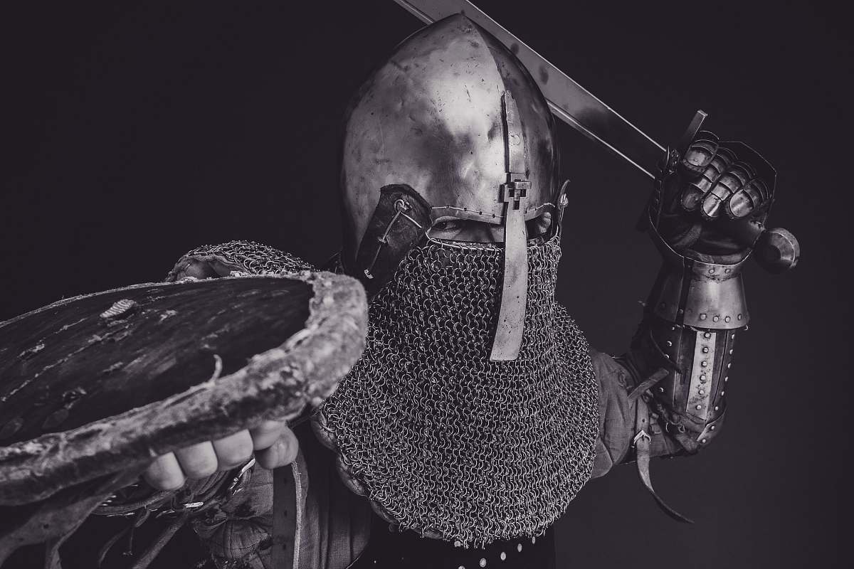 armor man with steel and chainmail armor holding sword grey