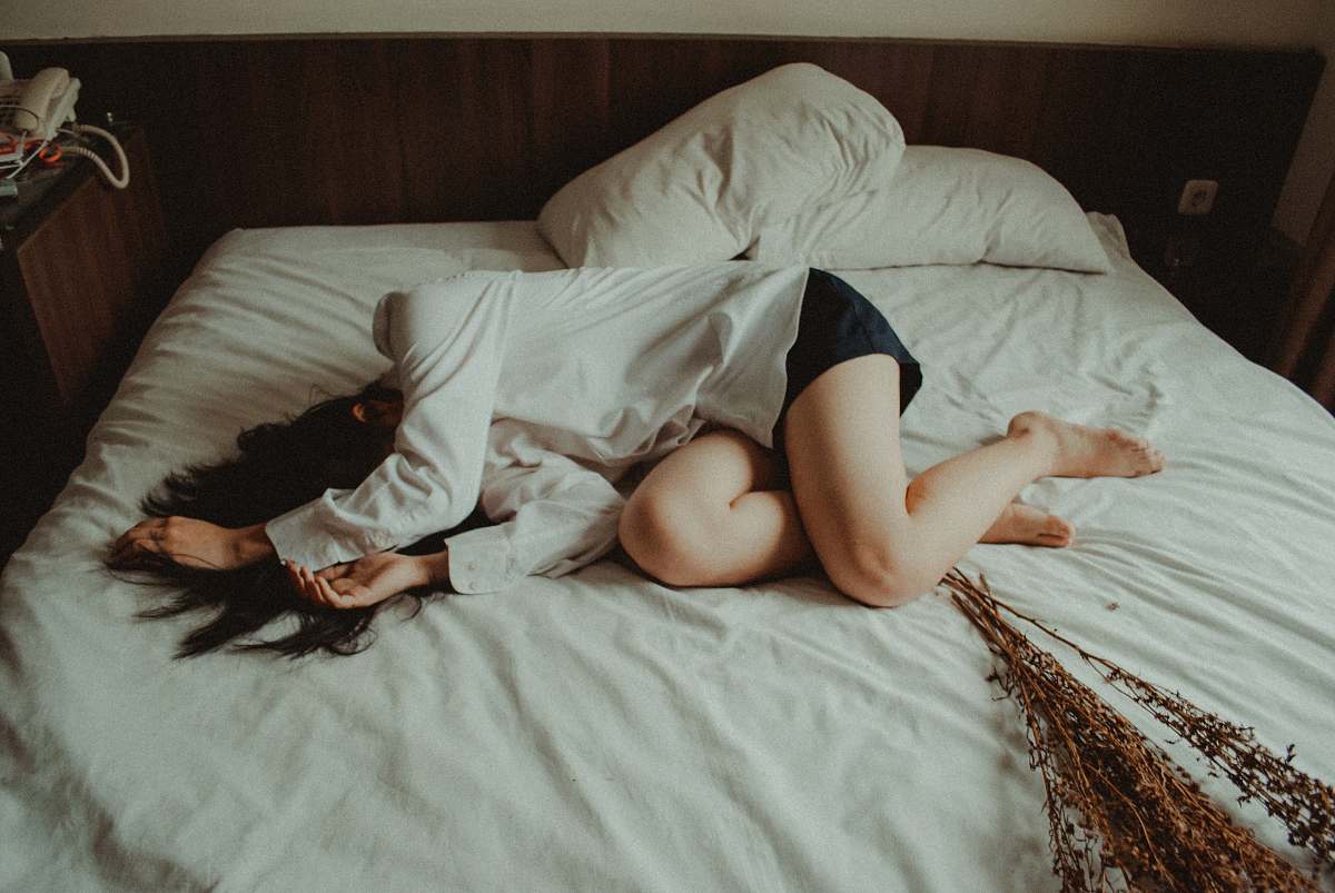 bed woman lying on bed depression