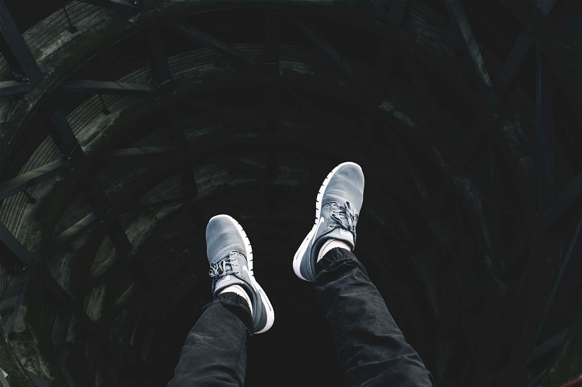shoes person showing pair of gray lace-up low-top sneakers shoe