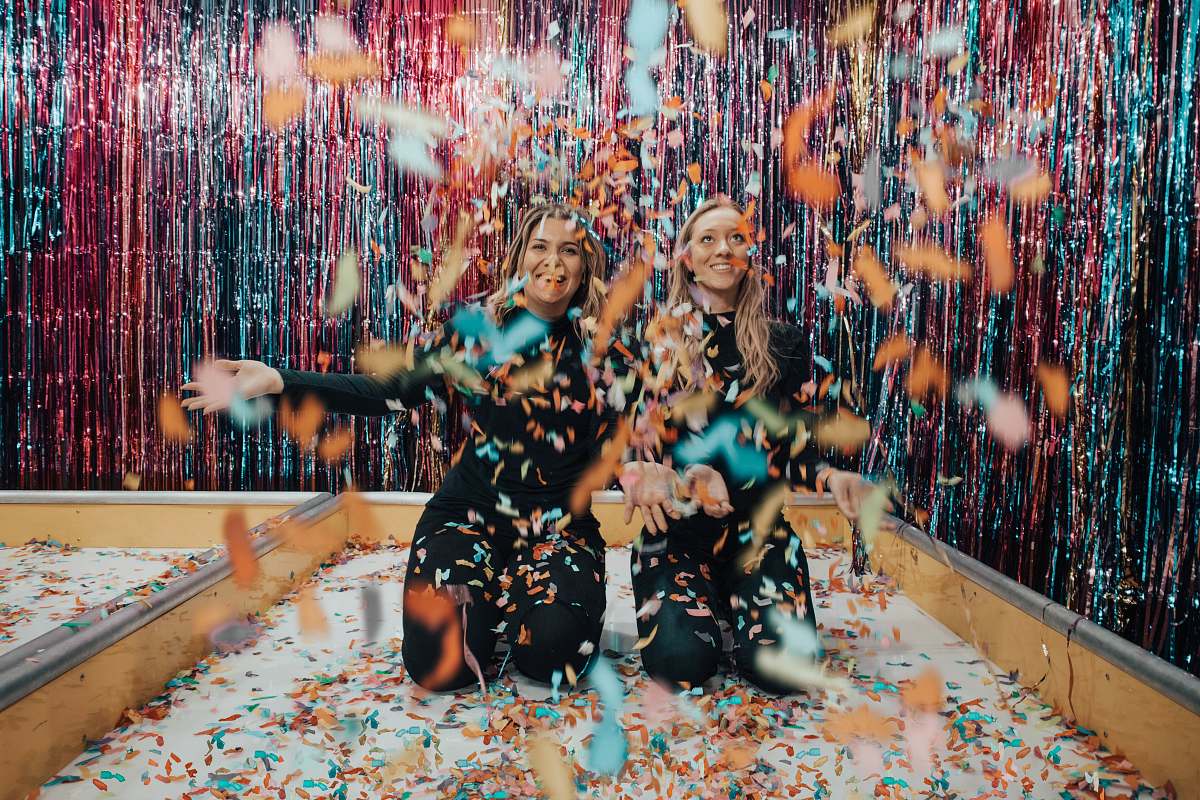 confetti two women enjoying confetti paper