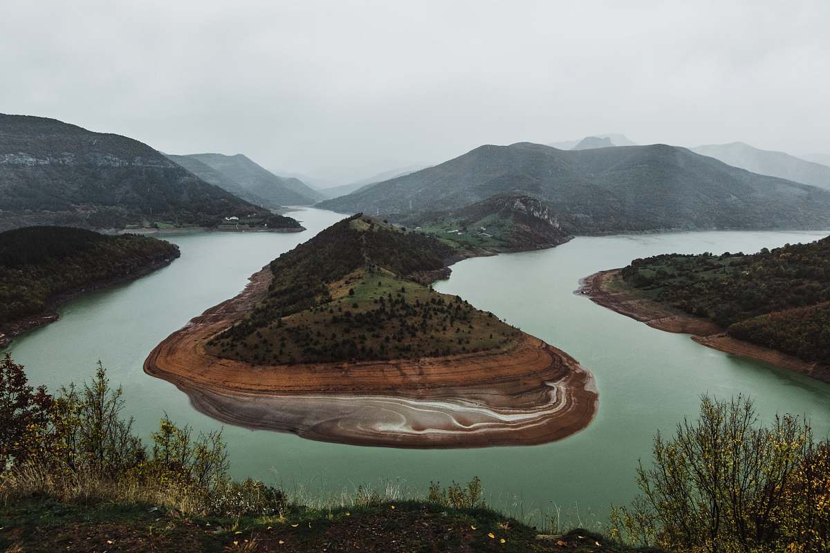 outdoors mountain near body of water during daytime land
