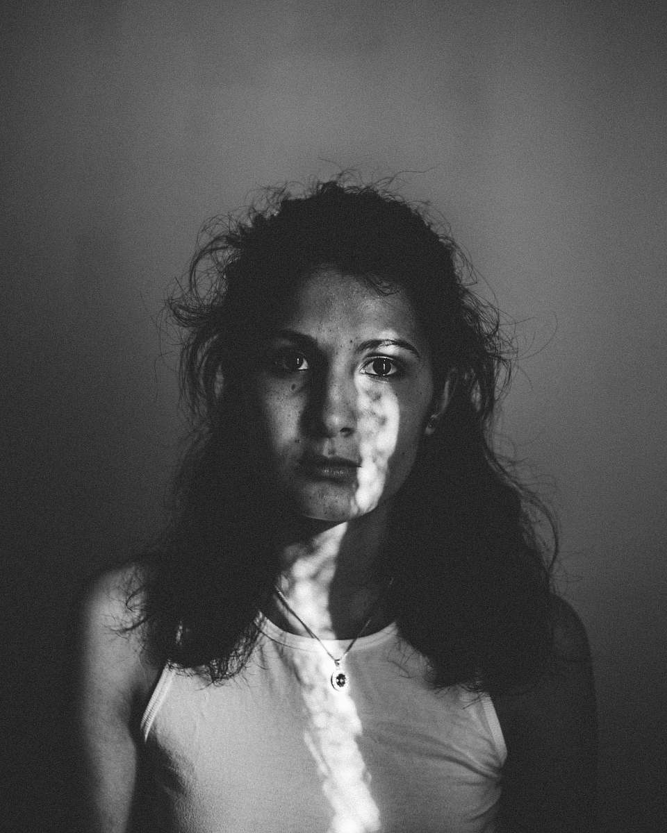 human grayscale photography of woman in tank top black-and-white