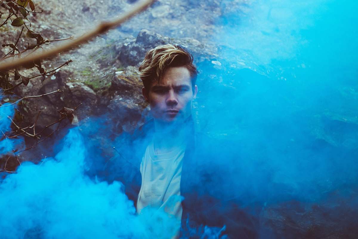 human man wearing black top smoke