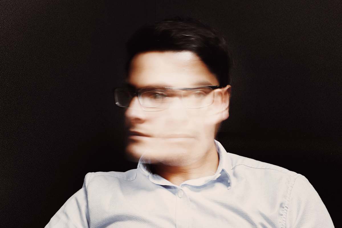 person man wearing white button-up collared top and black framed eyeglasses human