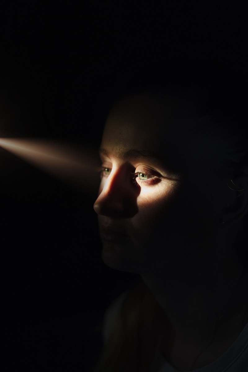person woman's face with sunlight on eyes human