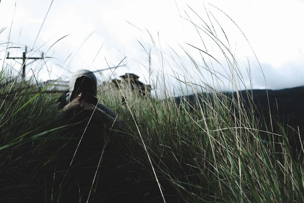 grass man in hoodie near grass flora