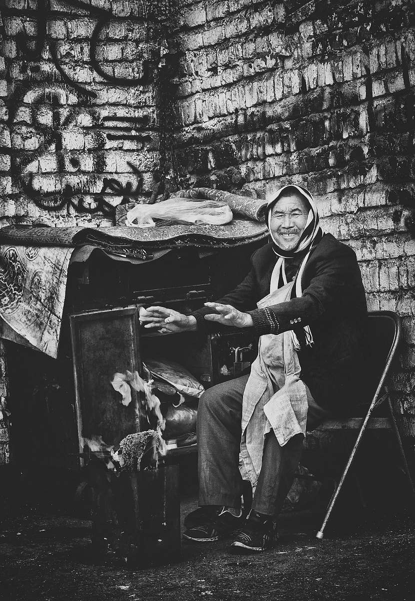 human man sitting on chair black-and-white
