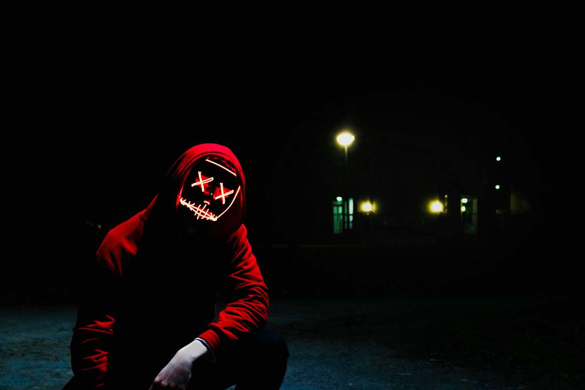 human man squatting during nighttime people