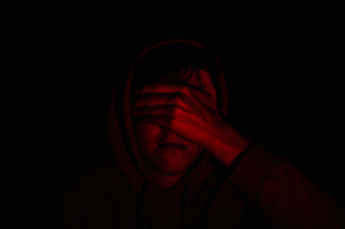 face person covering face with right hand hand