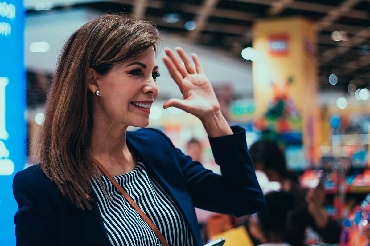 human woman raising her right arm happy school