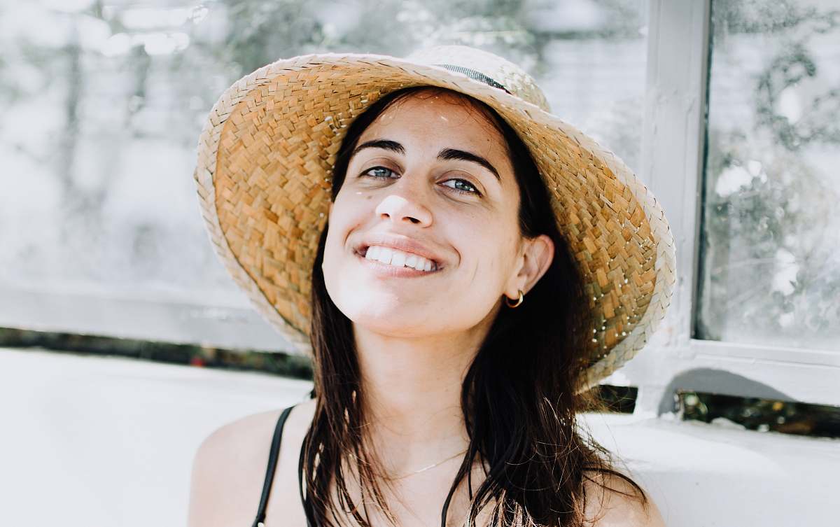 human woman wearing black strap top with sunhat people