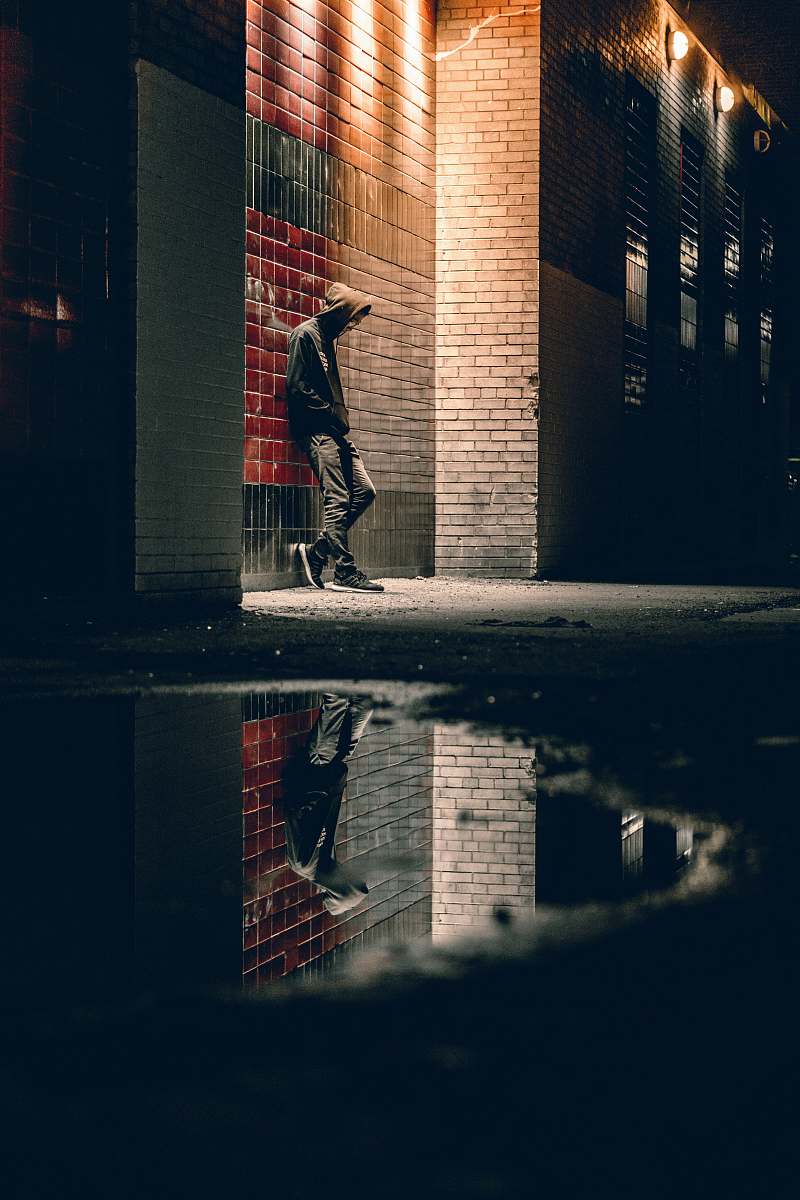 toronto man learning on concrete wall hoodie