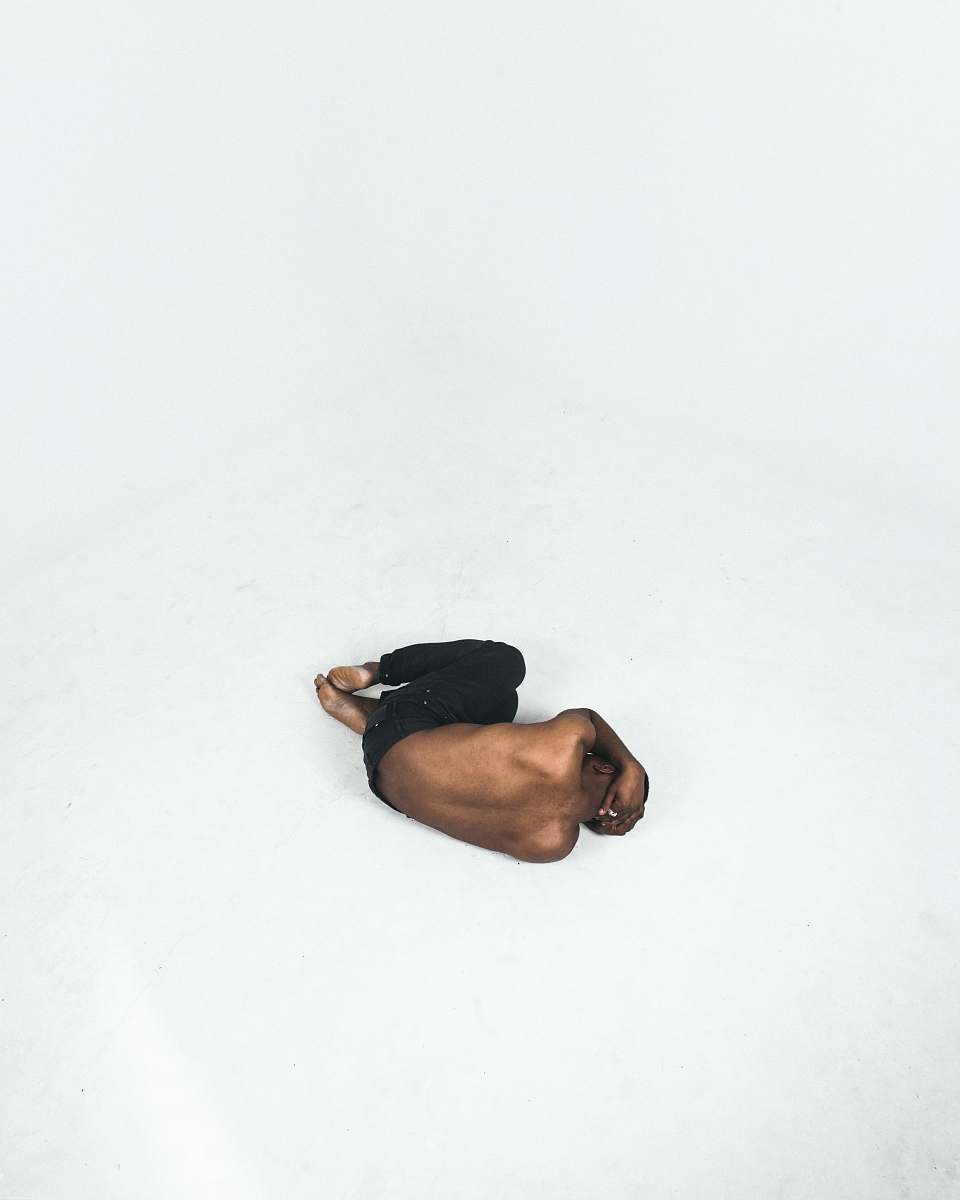 canada person lying down on white surface shirtless