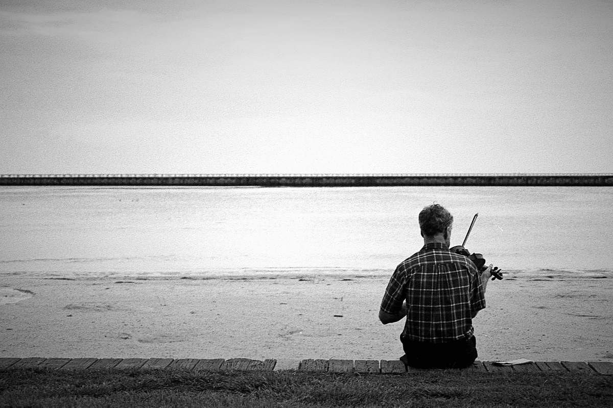 outdoors man playing violin on beach water