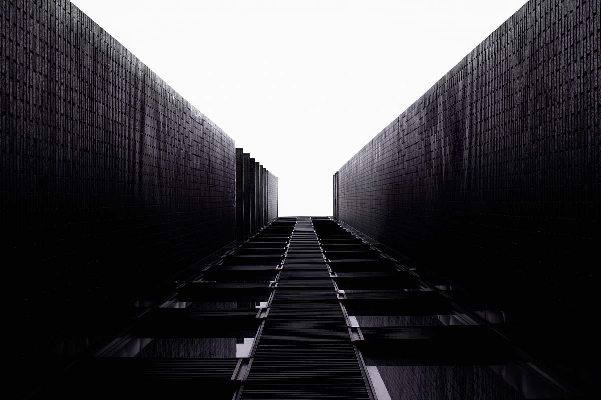 railway grayscale photo of a building train track
