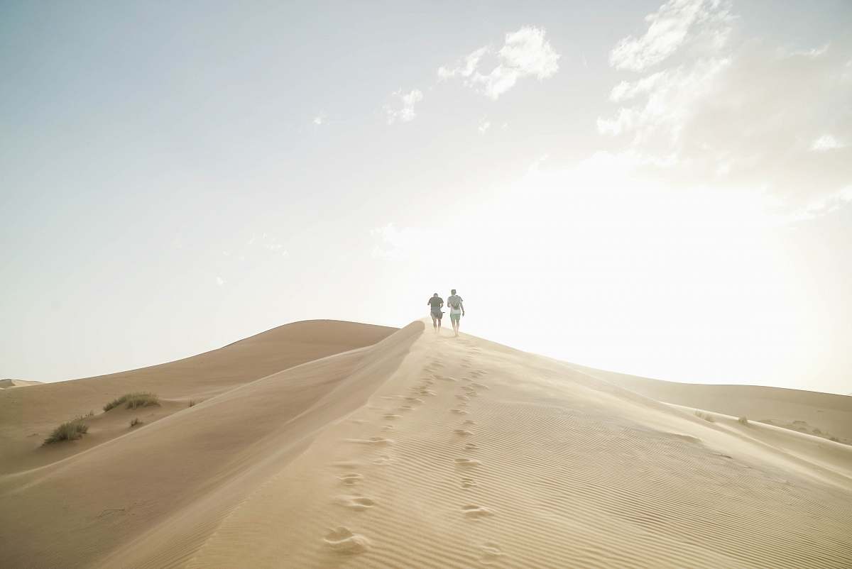nature person walking on desert during daytime outdoors