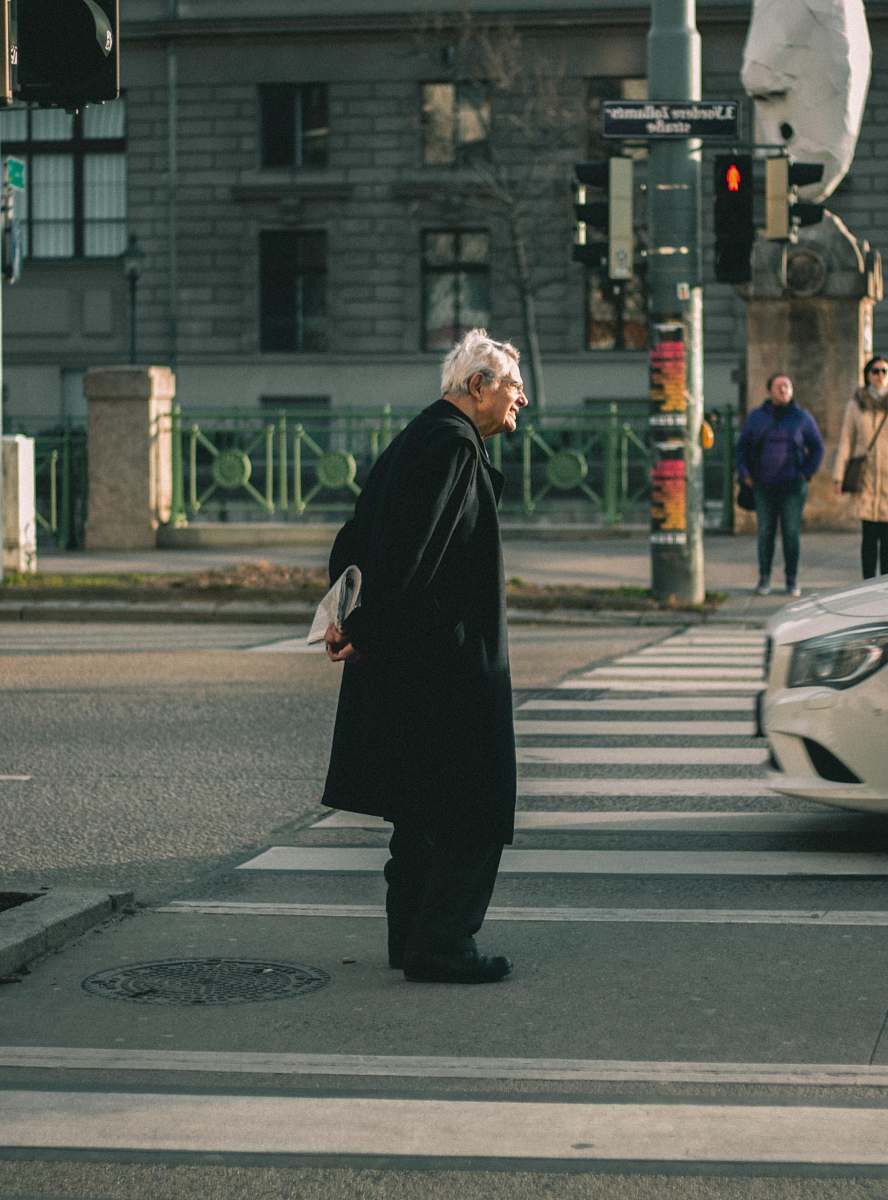 asphalt woman in black abaya standing on pedestrian lane during daytime tarmac