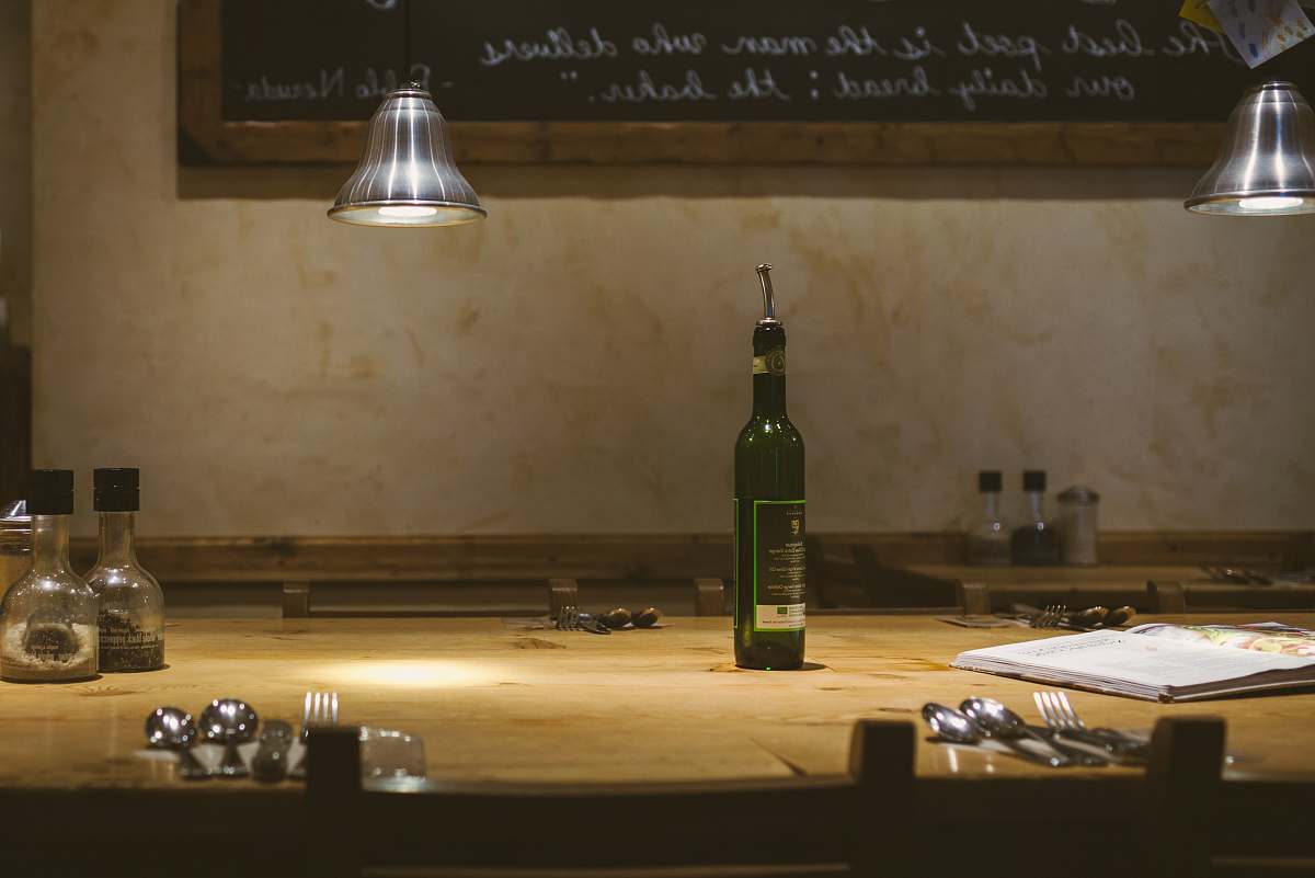 sink green and black glass bottle on brown wooden table cafe