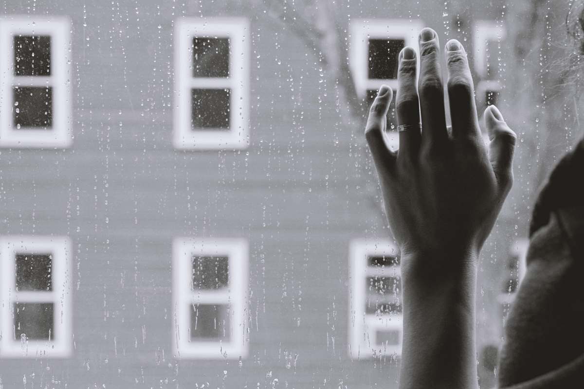 punnamchola grayscale photo of person holding glass window while raining india